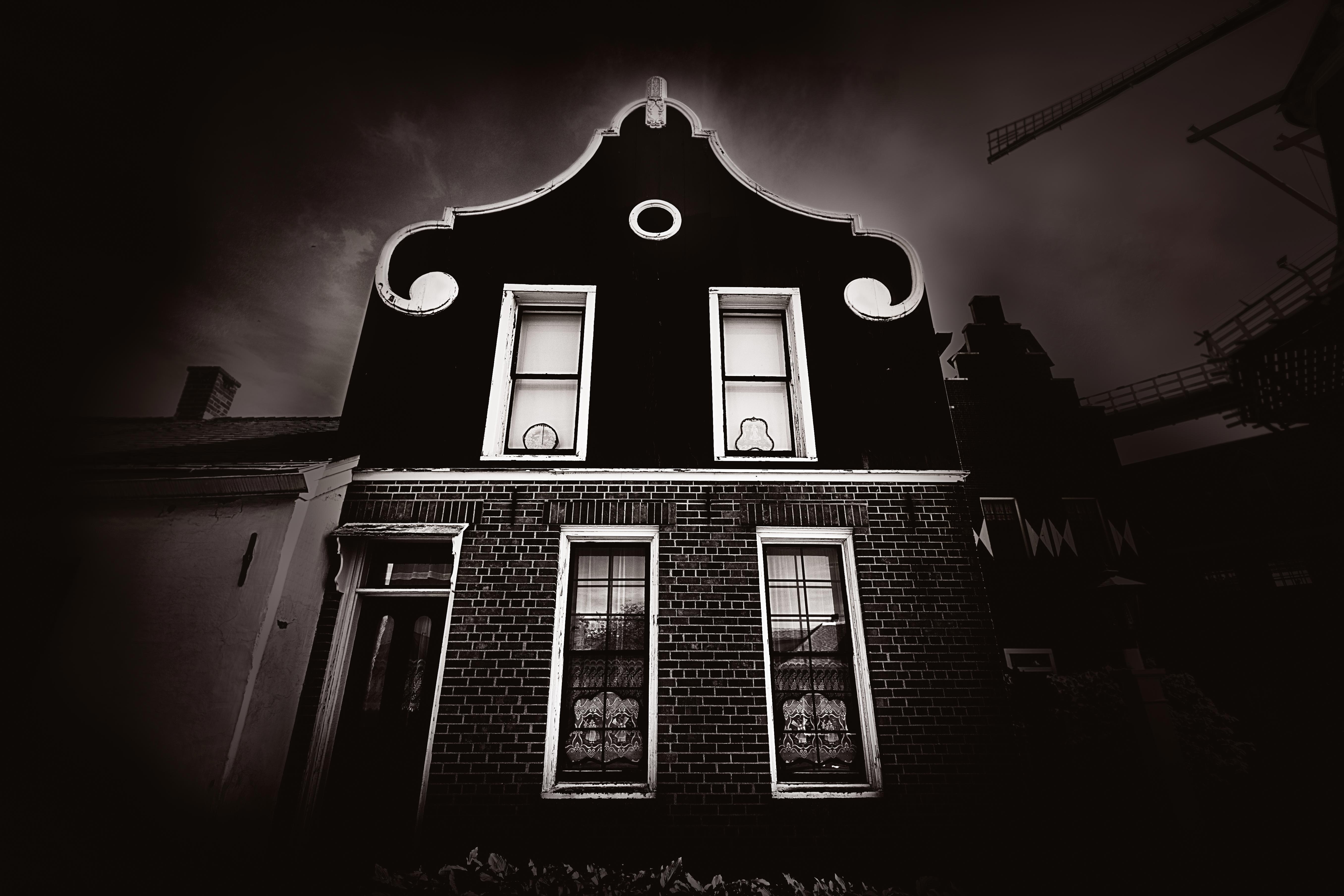 Dutch colonial building facade in Pella Historic Village under dramatic storm sky