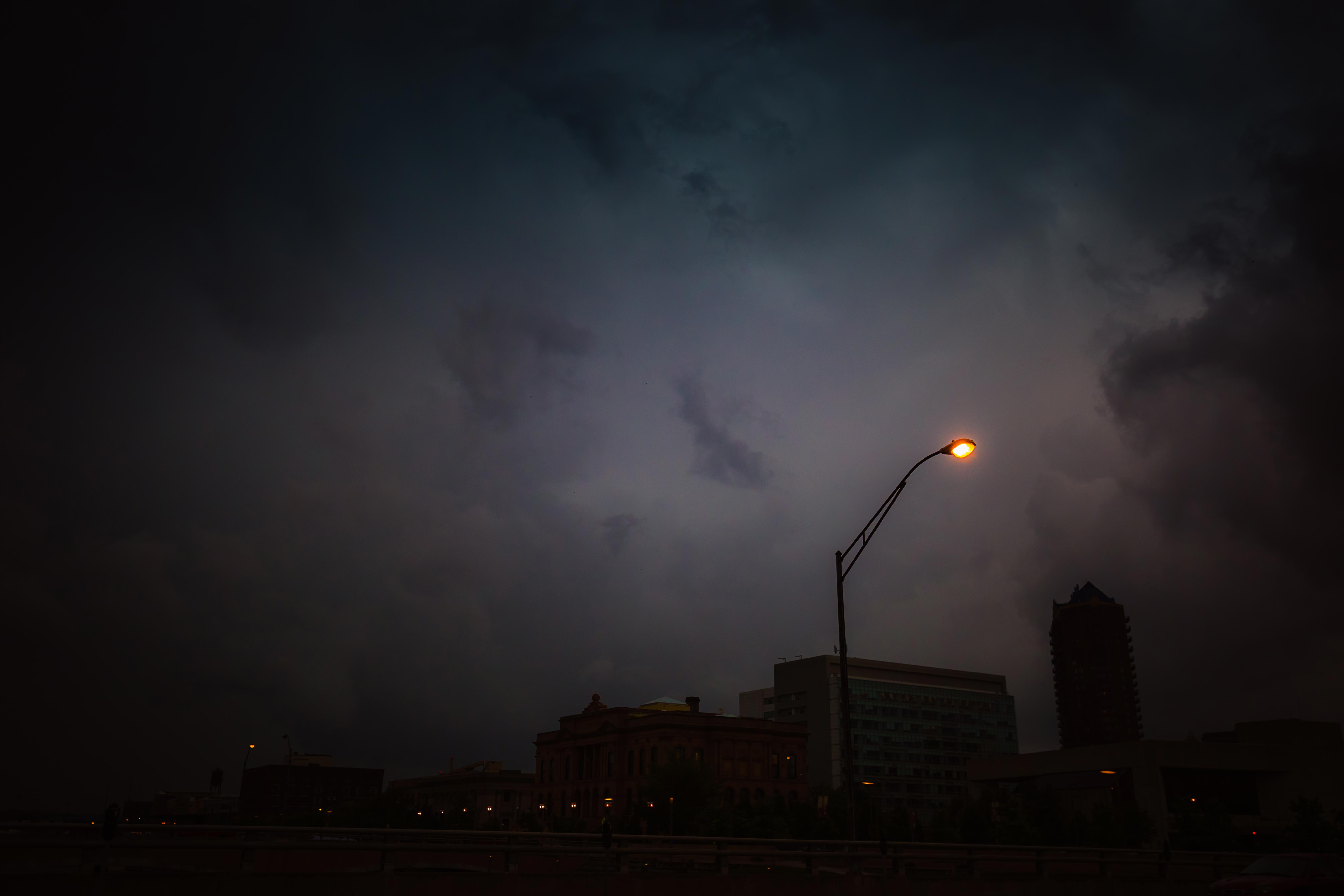 Lone streetlamp against twilight sky in downtown Des Moines