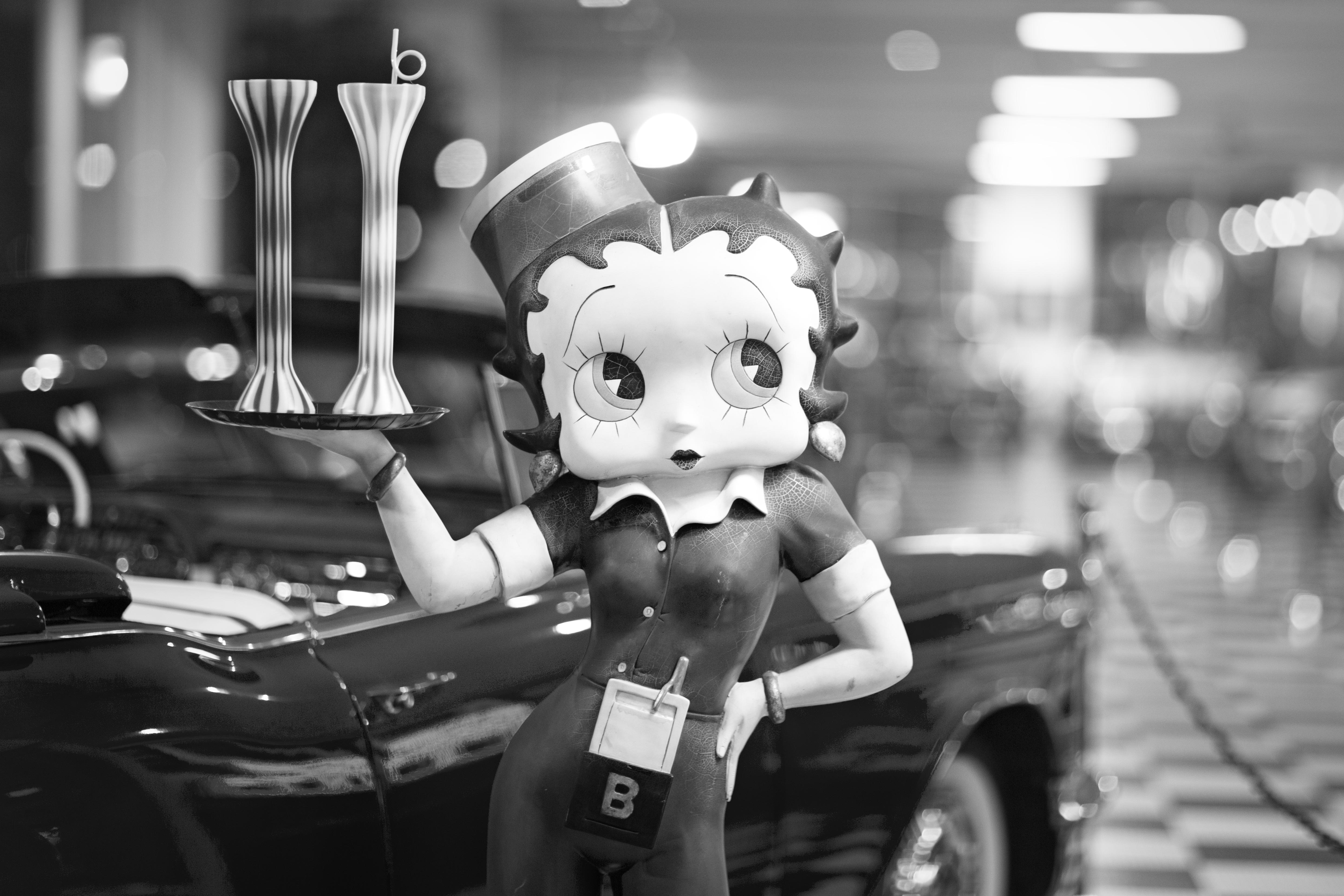 Betty Boop figurine in waitress uniform at vintage car museum